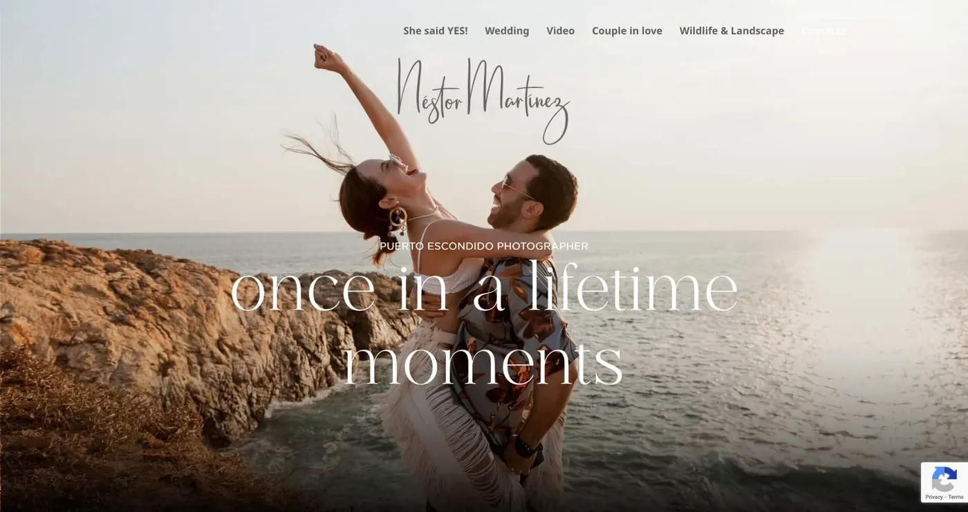 A couple joyfully embraces near a scenic coastal cliff at sunset, capturing a romantic, once-in-a-lifetime moment by the ocean.