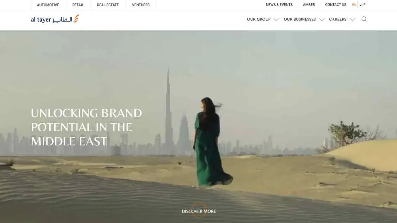 A person in a flowing dark dress stands on a sandy desert landscape with the Burj Khalifa towering in the background, under a clear sky, featuring the text "Unlocking Brand Potential in the Middle East."