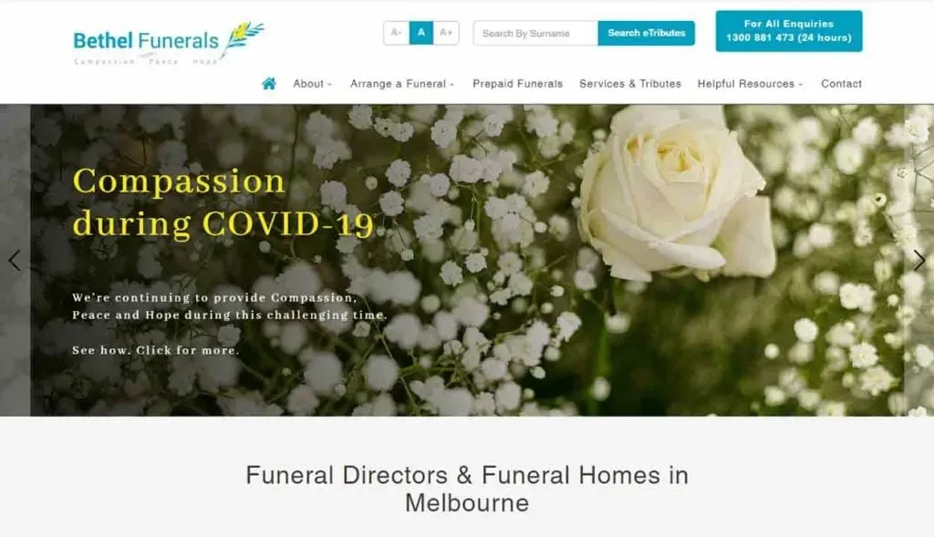 Website homepage of Bethel Funerals featuring a white rose and baby's breath flowers with text about offering compassion during COVID-19, alongside options for funeral arrangements and resources in Melbourne.