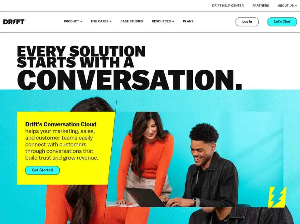A diverse team of two people collaborates enthusiastically over a laptop, with a prominent, motivating message on a vibrant blue and white background highlighting Drift's Conversation Cloud solution for building customer trust and growing revenue.