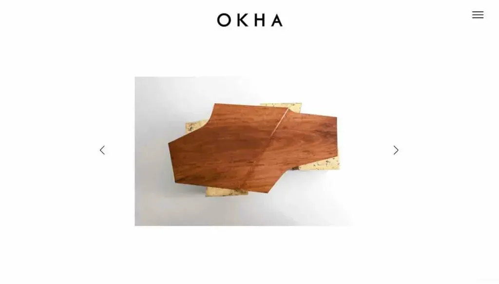 A uniquely shaped wooden coffee table with an asymmetrical design, showcasing rich brown wood grain, is displayed against a plain white background.