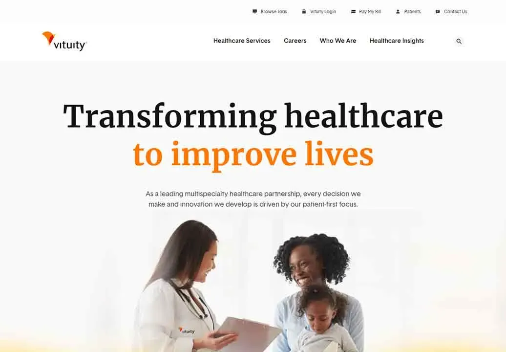 A female doctor in a white coat is shown smiling while holding a clipboard, standing next to a woman who is sitting and happily holding a child in her lap, against a background that features text about healthcare transformation to improve lives.