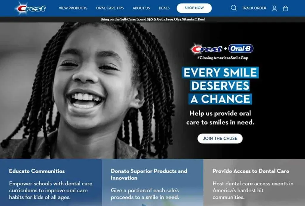 A smiling child with braided hair is featured on a promotional Crest and Oral-B webpage advocating for oral care access for children, along with a message: "Every Smile Deserves a Chance."