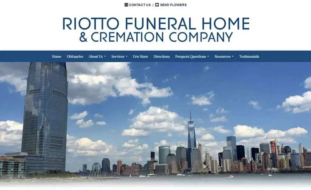 Skyline view of New York City with prominent skyscrapers under a cloudy blue sky, featured on the homepage of Riotto Funeral Home & Cremation Company website, highlighting their services and contact options.