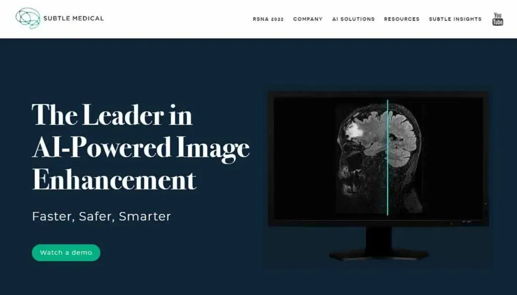 The image features a computer monitor displaying a brain scan with AI enhancements, overlaid with text promoting "The Leader in AI-Powered Image Enhancement" with a call-to-action button labeled "Watch a demo," set against a sleek, professional website banner.