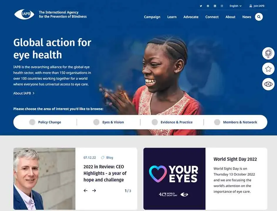 A smiling child is featured prominently against a blue background on a website homepage for the International Agency for the Prevention of Blindness, highlighting their focus on global eye health initiatives.