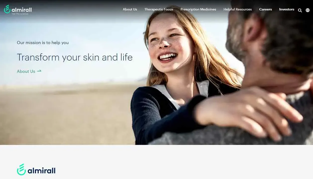 A young girl with long hair and a joyful expression is held by an older individual on a sandy beach, with a serene ocean in the background, accompanied by text promoting skin and life transformation, featuring the Almirall logo.