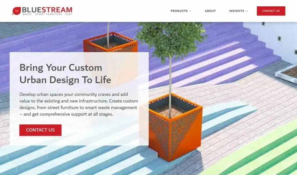 A modern urban design featuring colorful, striped concrete steps with vibrant orange planters containing leafy green plants, set against the backdrop of a contemporary building, highlighting innovative street furniture solutions.