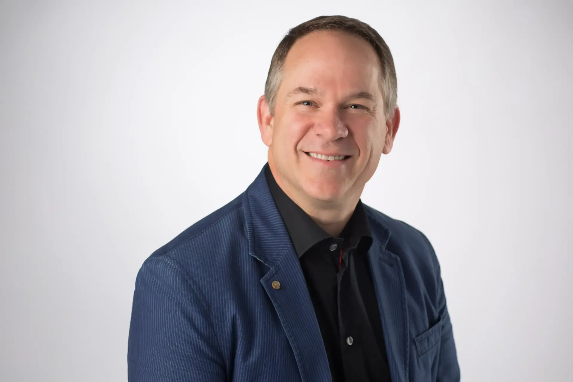 Kevin Crull, CMO of Sprint, smiling while wearing a blue blazer