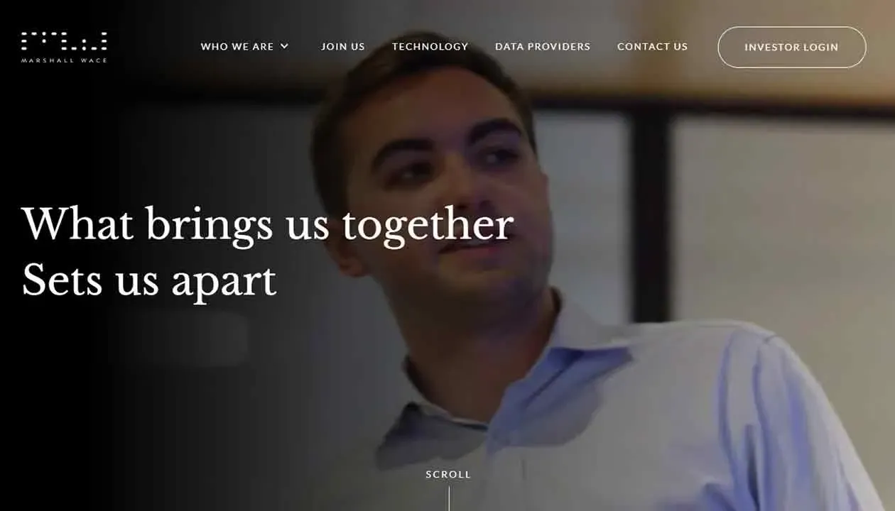 A person in a light blue shirt stands in a dimly-lit room with the text "What brings us together sets us apart" overlaid, highlighting themes of unity and uniqueness.