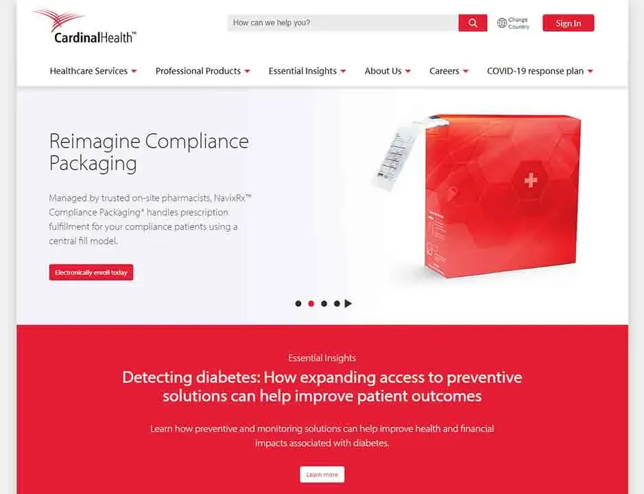 The image shows the homepage of a website for a healthcare company, featuring a section on compliance packaging with a red and white design, a red box with a medical cross icon, and a call-to-action button labeled "Electronically enroll today."