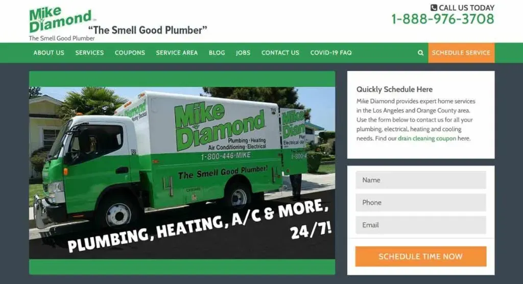 A green and white plumbing service truck, featuring the branding of Mike Diamond and the slogan "The Smell Good Plumber," is parked against a backdrop of trees, prominently displaying the services: plumbing, heating, and air conditioning, available 24/7.