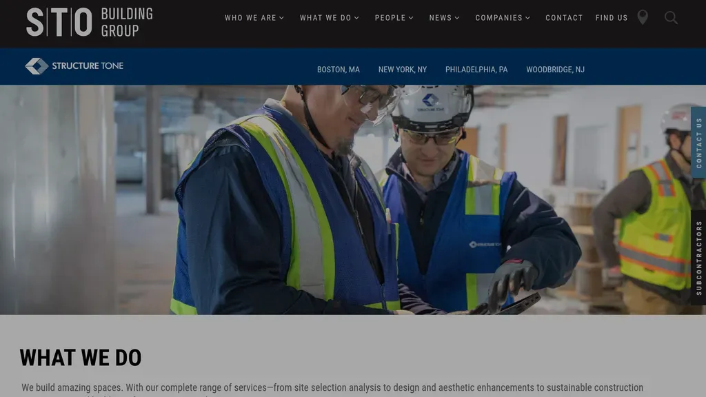 Structure Tone homepage with a dark full-width jobsite photo and "What We Do" intro