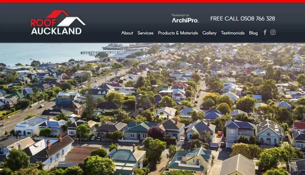 Aerial view of a suburban coastal neighborhood in Auckland showcasing rooftops, tree-lined streets, and the sparkling waterfront against a clear sky, with the banner featuring "Roof Auckland" and contact information.