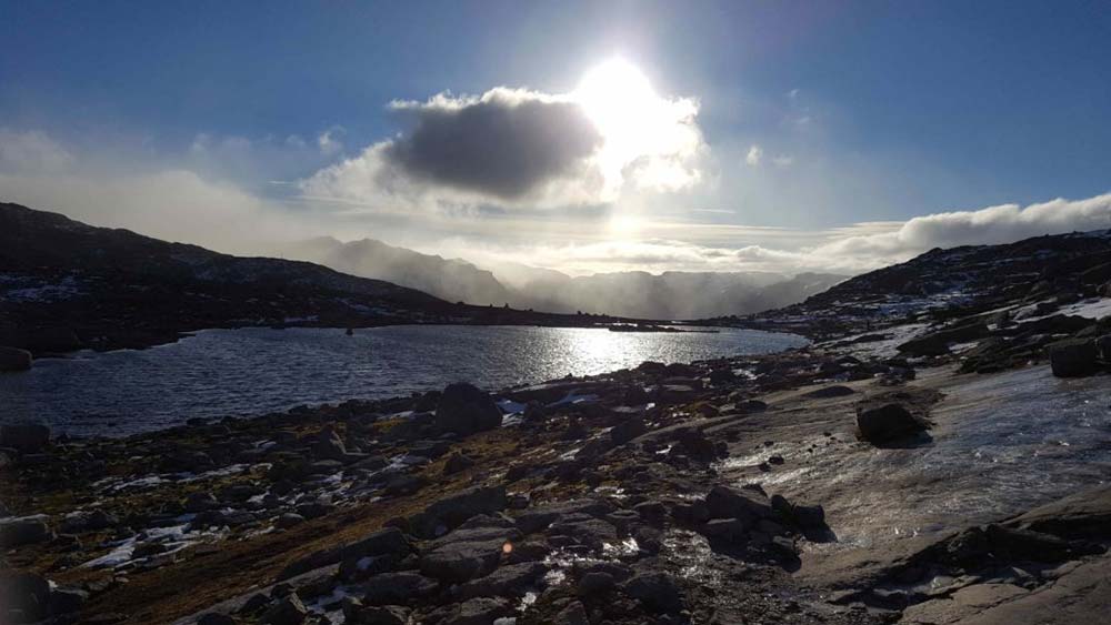 Hiker overlooking Norwegian fjords on the Trolltunga trail